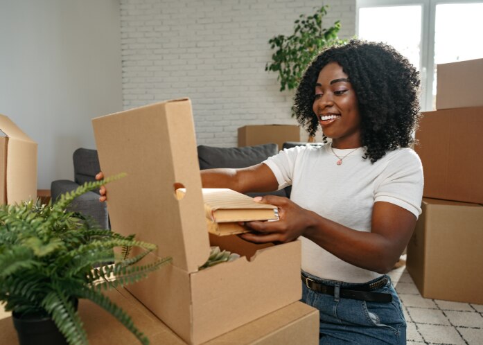 woman packing things in a box