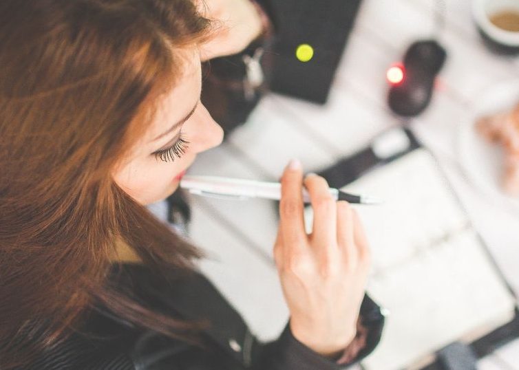 Woman pondering things at her desk