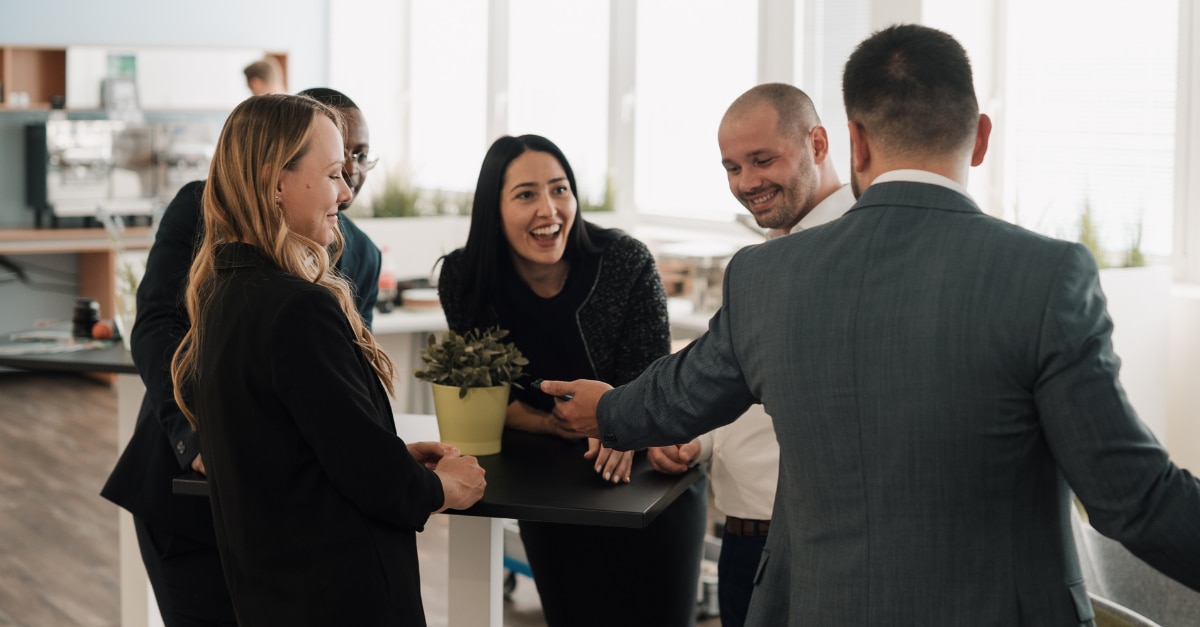 People chatting around a cocktail table