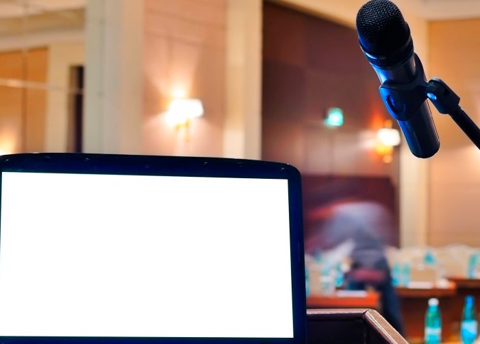 Laptop and microphone at a podium