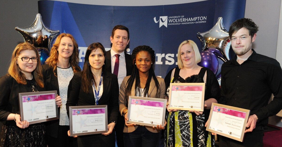 Group of students holding awards