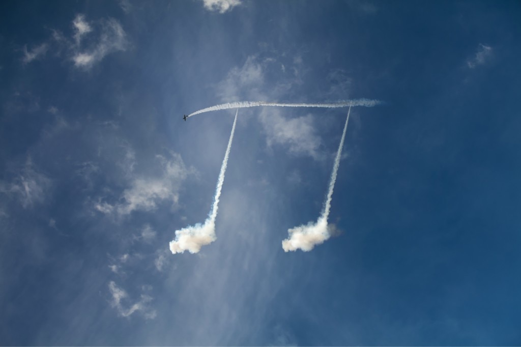Skywriting plane drawing music notes