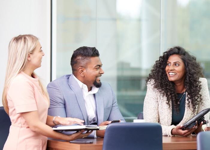 Colleagues sitting at a table talking