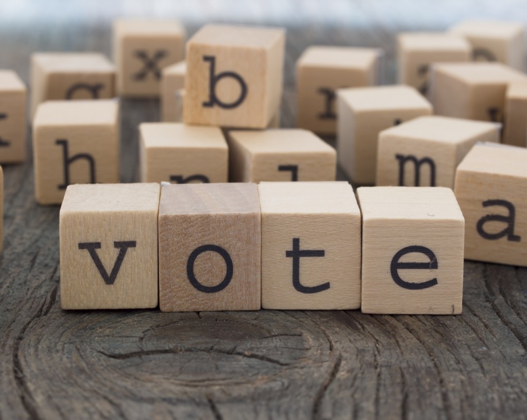 Alphabet blocks with some configured to spell "vote"