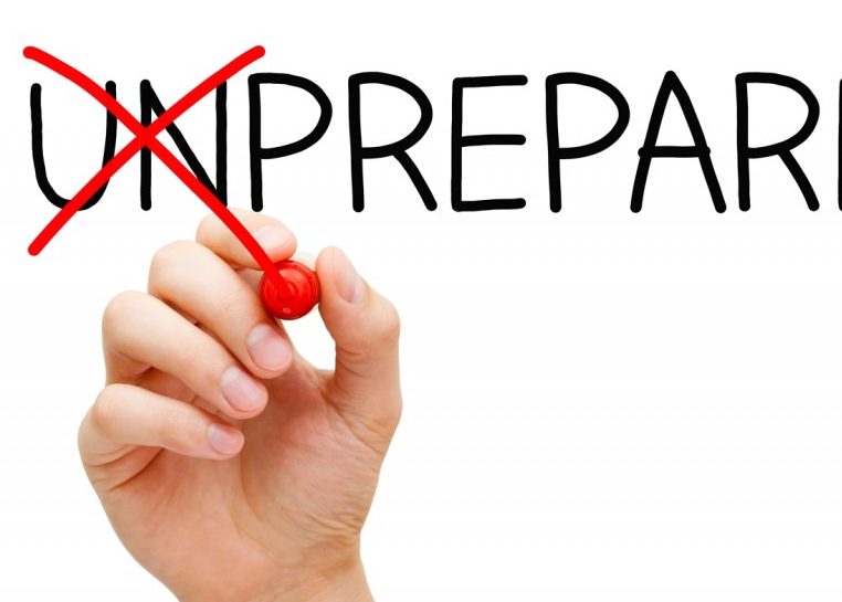 Hand with red marker crossing out "Un" in front of "prepared"