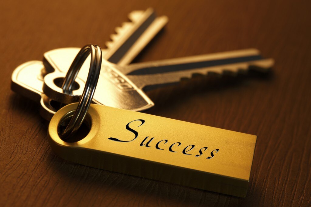 Gold keys with a gold keychain that says "success"