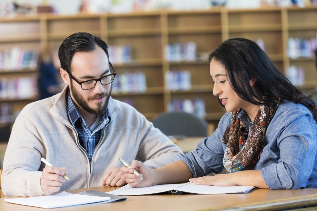 Students reviewing notes in a library