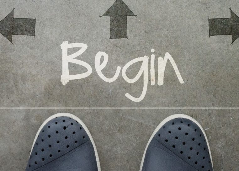 Feet on ground with "Begin" written surrounded by arrows