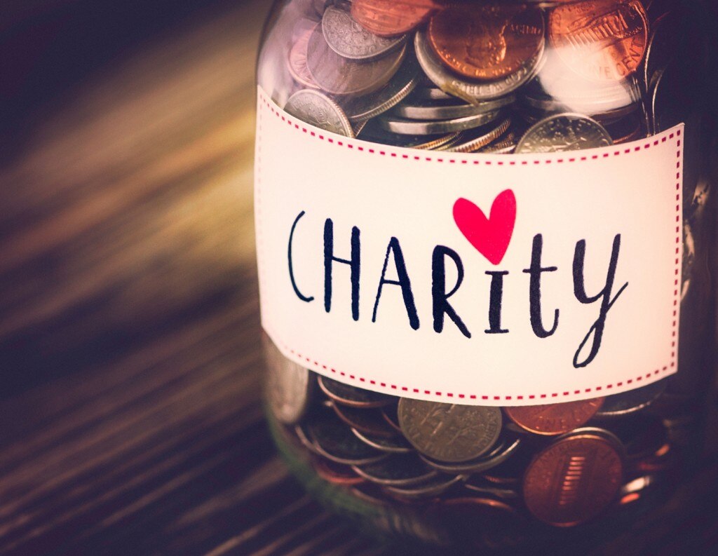 Jar of coins that says "Charity"