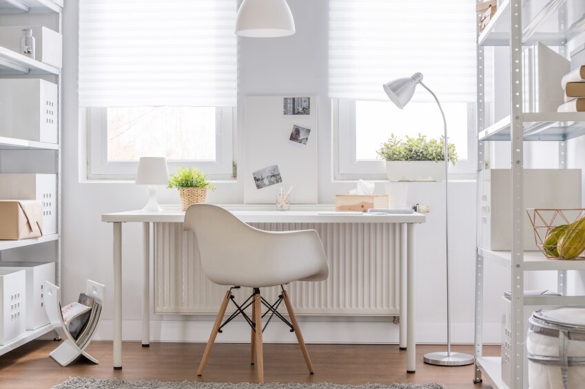 Neutral desk, chair, wall, and accessories in a home office