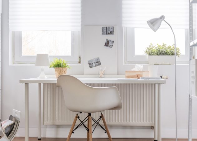 Neutral desk, chair, wall, and accessories in a home office