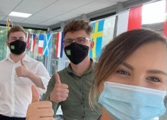 Enterprise employees wearing masks in the office for a selfie