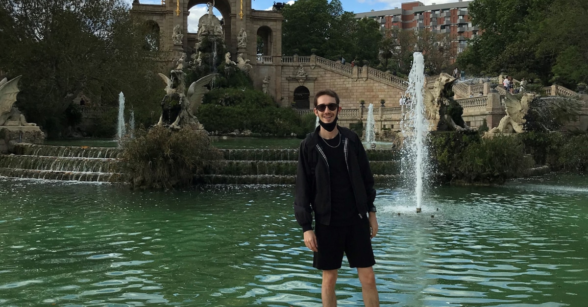 Nicholas standing in front of a fountain