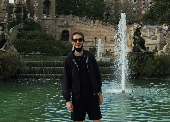 Nicholas standing in front of a fountain