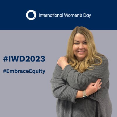 Leigh embrassing herself on #IWD2023 background