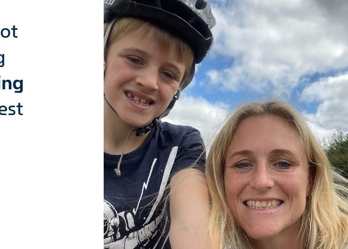 Jo with her son in a bike helmet with a quote