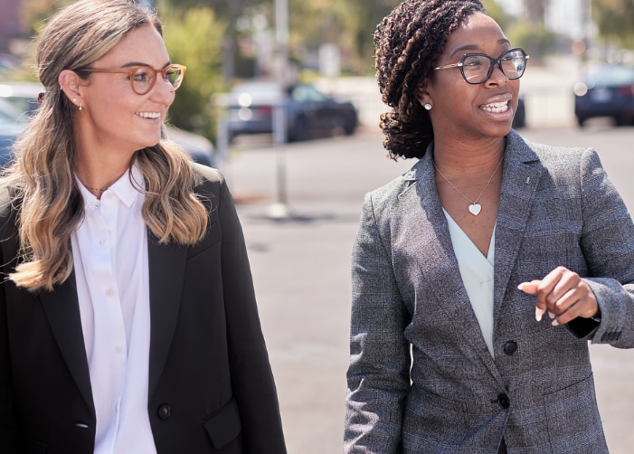 Two female employees walking in a parking lot