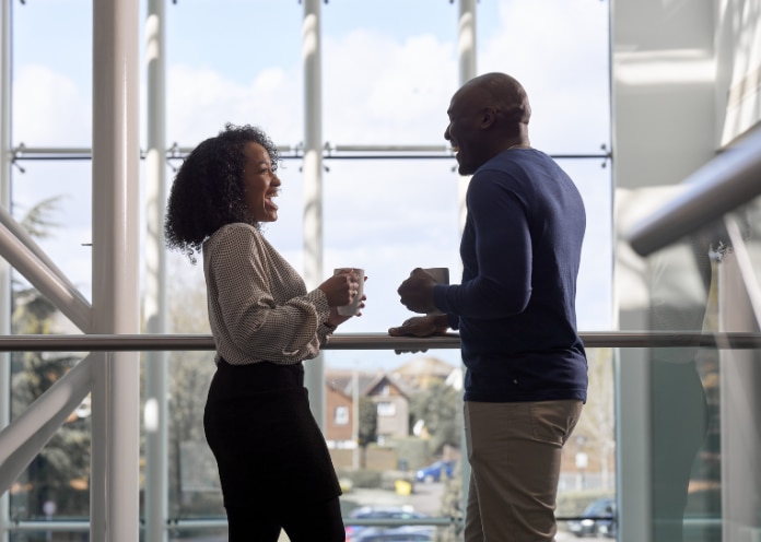 Two Enterprise Mobility employees chatting in Egham head office 