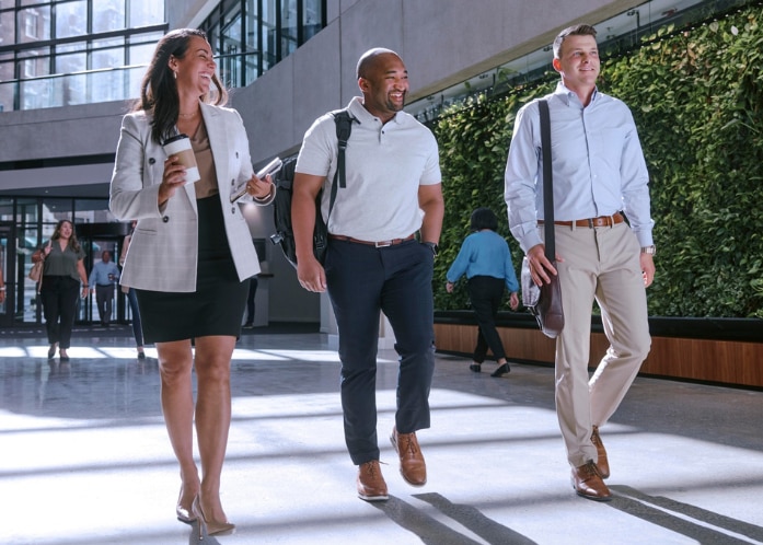 Enterprise Mobility employees walking down corridor at work in their new careers