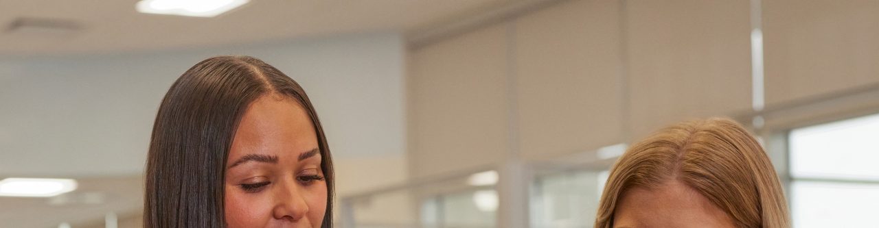 two women at a table in an office