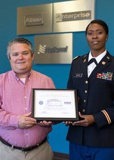 A man and a woman hold a certificate together