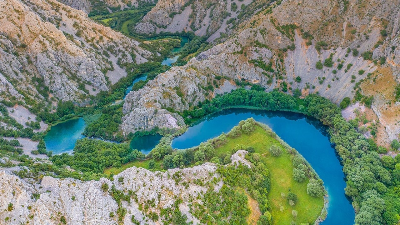 An aerial shot of a river and greenery