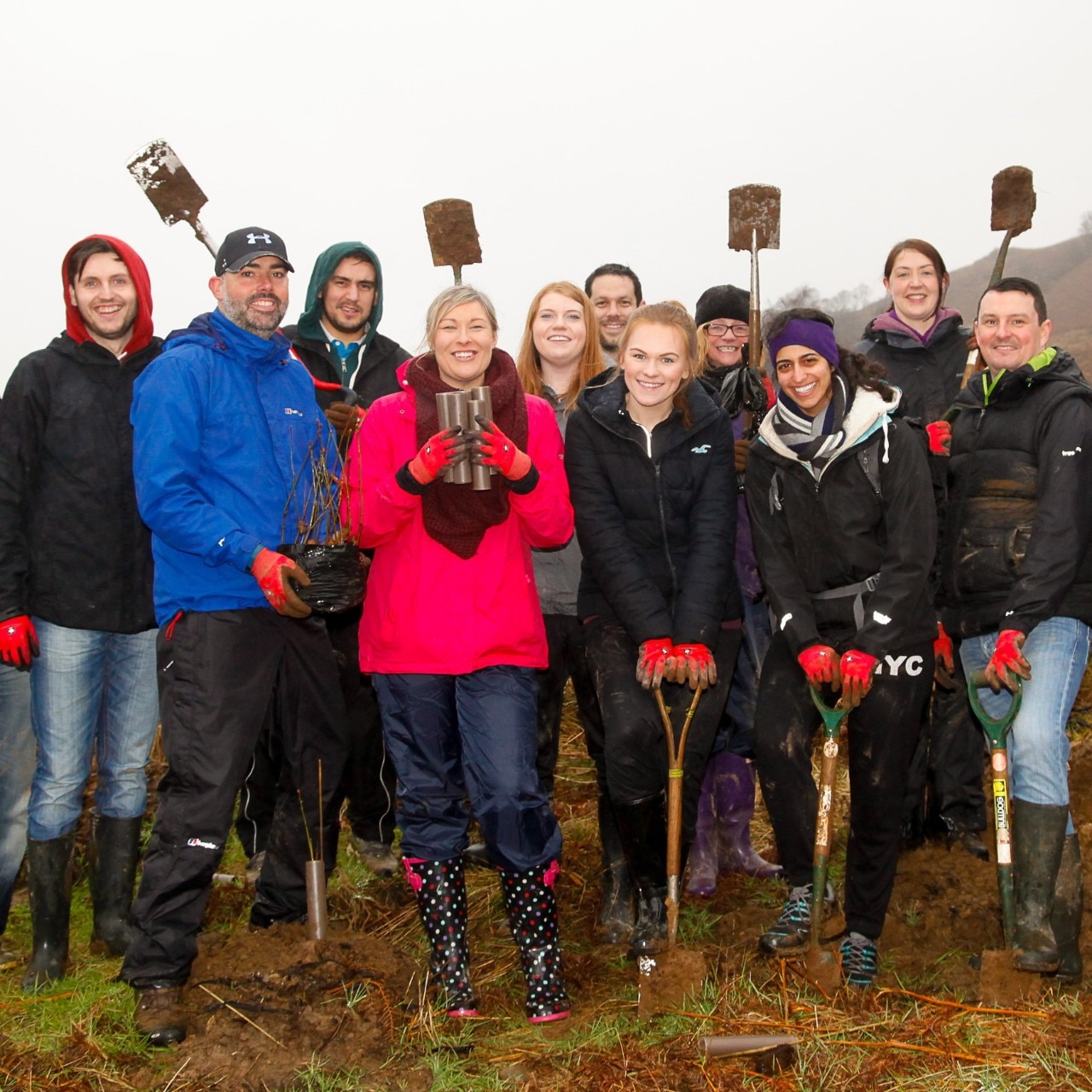 A group of Enterprise employees pose for a picture with shovels.