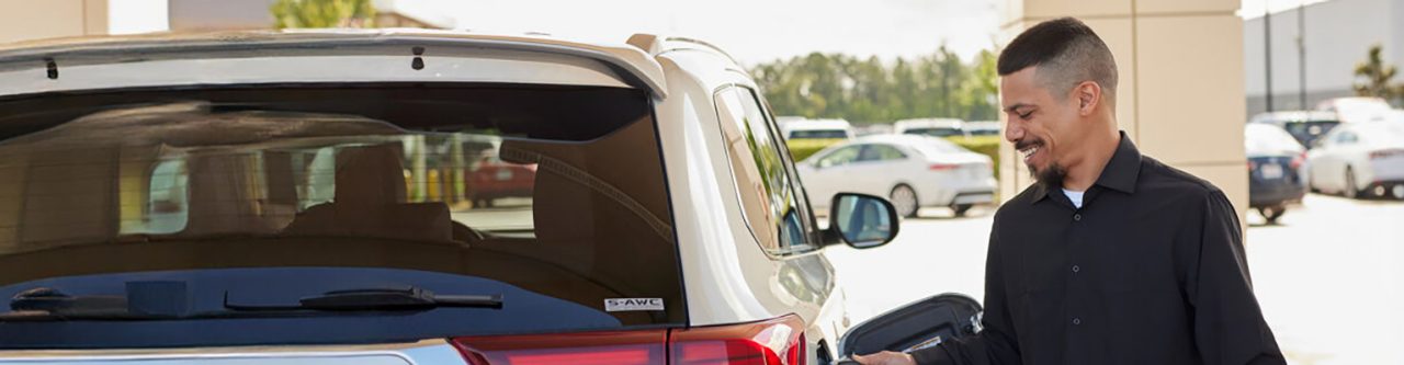 Enterprise Mobility employee recharging an electric vehicle