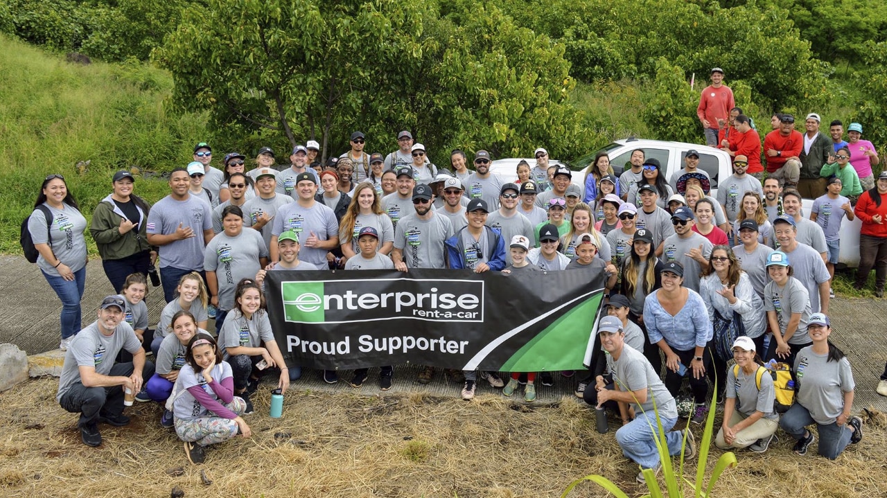 Group of Enterprise Rent-A-Car employees pose for a picture.