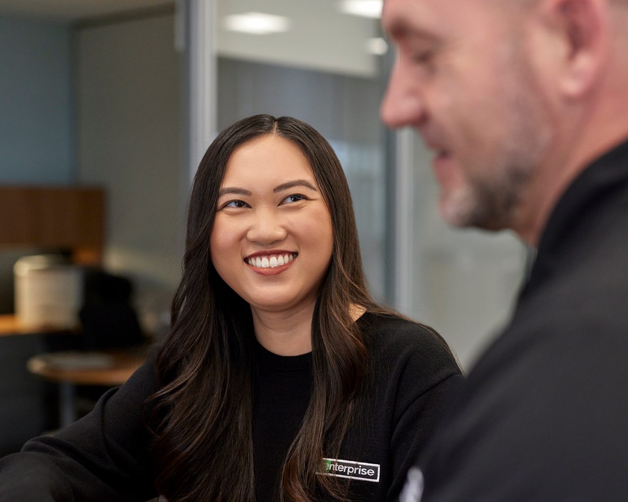 Enterprise Mobility female employee looks at coworker